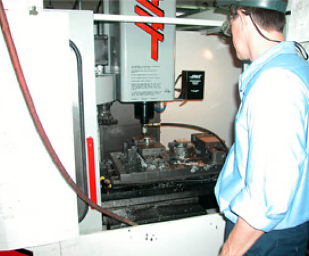 Man wearing safety glasses watching the equipment